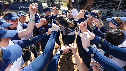 QU softball team huddles up before their game against Holy Cross