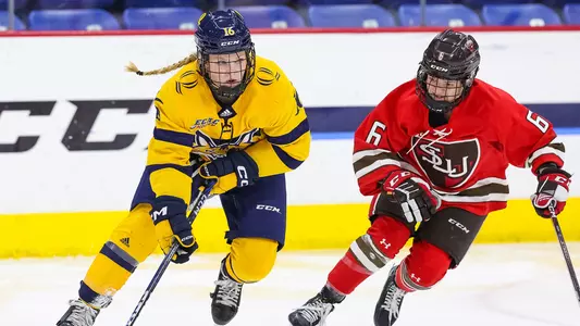 Shay Maloney carries the puck up the ice against a St. Lawrence student-athlete