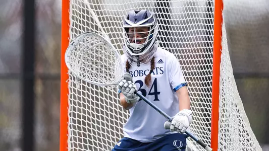 Senior goalkeeper Kat Henselder defends the net with her stick head to the right