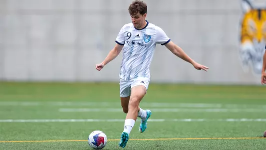 Tomas Svecula kicks a ball vs. URI