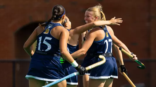 Field hockey team celebrates a goal