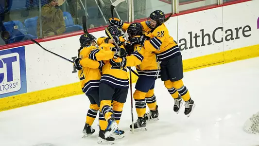 Women's ice hockey celebrates goal against SLU