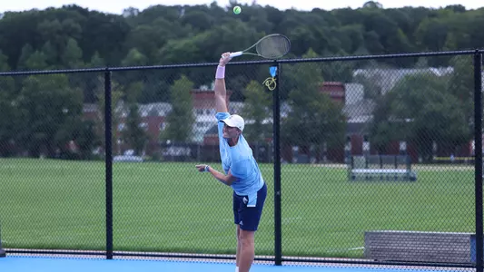 Finn burridge hitting a serve
