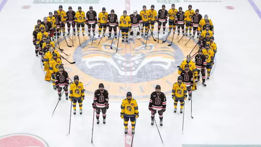 QU and Brown women's ice hockey making a shape of a heart at center ice of M&T Bank Arena (Jan. 25. 2025)