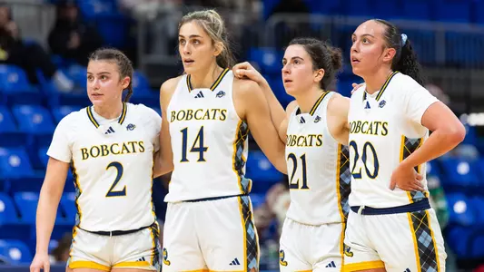 Ella Ryan, Emma Lizotte, Jackie Grisdale, and Sydney Ryan Huddle During Free Throw (VS. Maine, Dec. 14, 2025 in Hamden, Conn.)