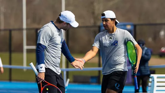 Daniel Velek and James Lorenzetti high five during a match in Hamden (March 28, 2025)