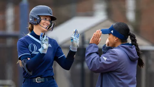 Mary Fogg high fives Mandie Perez after a hit in a game against Mount in Hamden (April 13, 2025)