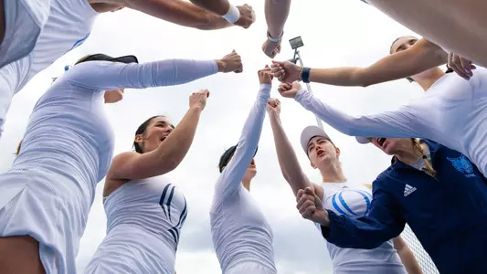 Women's tennis breaks down a huddle in match in Hamden against Merrimack (March 29, 2025)