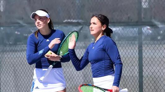 Willow Renton and Caitlin Flower high five after a point in match at Fairfield (April 17, 2025)