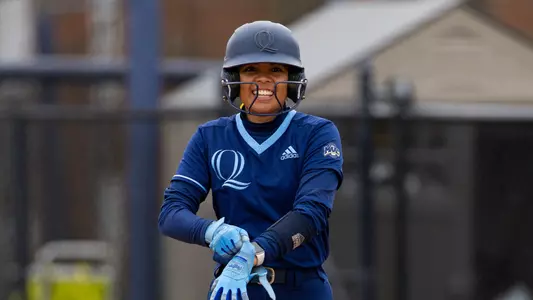 Ava Tabangcura smiling on first base in a game against Mount in Hamden (April 13, 2025)