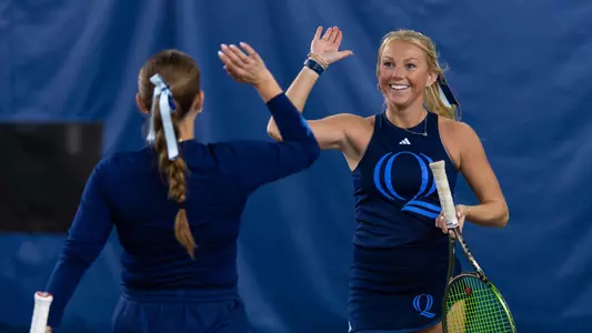Caroline Schulson and Jordan Bradley high five after a point in a match against Mount at NHHR (April 12, 2025)