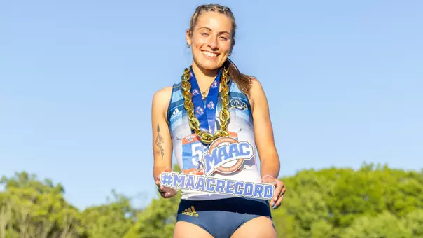 Ally Zaffina Poses with MAAC Record Sign at Top of Podium