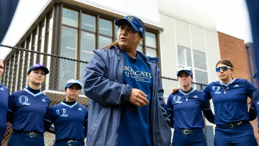 Hillary Smith talking to the QU Softball Team before a game against Mount (April 13, 2025)