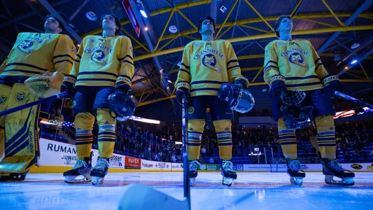 Players on the ice before the national anthem (Feb. 8, 2025 in Hamden, Conn.)