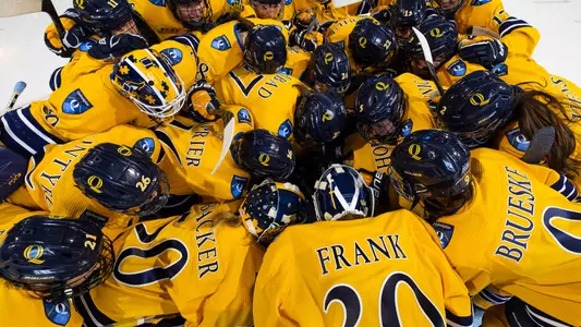 Women's ice hockey team huddles around the net before a game against Sacred Heart (Dec. 3, 2024)