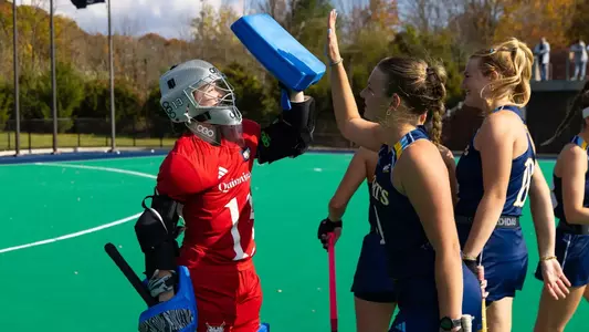 Meike van Schoot and Senne Fassbender high-fiving after win against Stonehill (Oct. 30, 2026 in Hamden, Conn.)