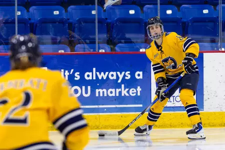 Kahlen Lamarche passing the puck to Jade Barbirati against Dartmouth (1.16.26 in Hamden, C.T.)