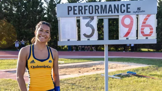 Talia Graham Poses Next to Her MAAC Championship Record Board (May 9, 2026 in Emmitsburg, Md.)