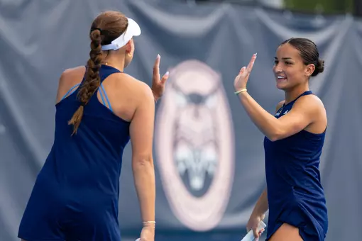 Willow Renton high-fiving partner Caitlin Flower during fall match against New Haven (Sept. 11, 2026 in Hamden, Conn.)