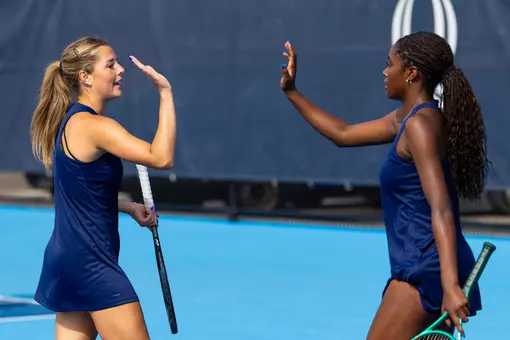 Isabella Baker and Nola Jones high-fiving in doubles against New Haven (Sept. 11, 2026 in Hamden, Conn.)