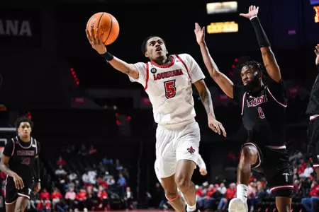 01/26/2023 Louisiana vs Troy MBB. Final score Louisiana 72 Troy 57. Photo by Benjamin R. Massey. About photo: Jalen Dalcourt lays the ball up against Troy.