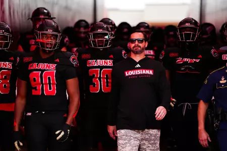 Head Coach, Michael Desormeaux leads the team down the tunnel October 7, 2023 Louisiana vs Texas State Football in Lafayette, LA at Cajun Field. Final score Louisiana 34 Texas State 30. Photo by Benjamin R. Massey/Ragin Cajun Athletics