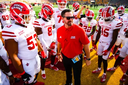 Head Coach, Michael Desormeaux talks in pregame huddle September 30, 2023 Louisiana @ University of Minnesota Football in Minneapolis, MN at Huntington Bank Stadium. Final score Louisiana 24 Minnesota 35. Photo by Benjamin R. Massey/Ragin Cajun Athletics