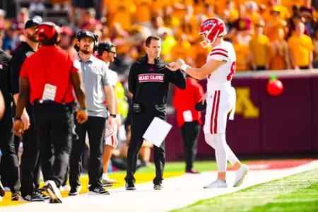 Special Teams Coordinator/Director of Quality Control & Analytics, Luke Paschall fist bumps Thomas Leo September 30, 2023 Louisiana @ University of Minnesota Football in Minneapolis, MN at Huntington Bank Stadium. Final score Louisiana 24 Minnesota 35. Photo by Benjamin R. Massey/Ragin Cajun Athletics