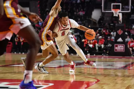 Kobe Julien drives to the basket against Loyola