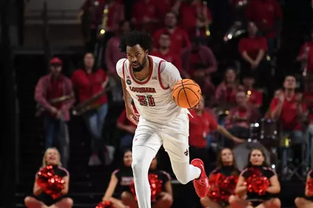 Jordan Brown dribbles the ball up the court against USA