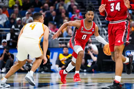 Themus Fulks dribbles the ball against Tennessee March 16, 2023. Louisiana vs Tennessee in the NCAA Tournament First Round at the Amway Center in Orlando, FL. Final score Louisiana 52 Tennessee 55. Photo by Benjamin R. Massey/Ragin Cajuns Athletics.