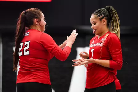 Mya Wilson high fives teammate with tongue out August 12, 2023 Louisiana Volleyball red vs white scrimmage at Historic Earl K. Long Gymnasium at Antoun Court. Final Score Red 0 White 2. Photo by Benjamin R. Massey/Ragin Cajun Athletics