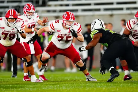 Kaden Moreau makes a block September 16, 2023 Louisiana vs University of Alabama Birmingham Football in Birmingham, AL at Protective Stadium. Final score Louisiana 41 UAB 21. Photo by Benjamin R. Massey/Ragin Cajun Athletics