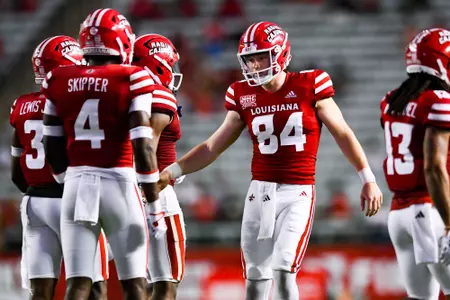 Thomas Leo high fives teammates after the punt September 23, 2023 Louisiana vs University of Buffalo Football in Lafayette, LA at Cajun Field. Final score Louisiana 45 Buffalo 38. Photo by Benjamin R. Massey/Ragin Cajun Athletics
