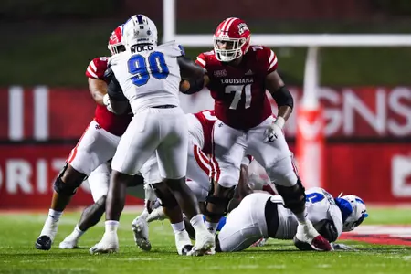 George Jackson makes a block September 23, 2023 Louisiana vs University of Buffalo Football in Lafayette, LA at Cajun Field. Final score Louisiana 45 Buffalo 38. Photo by Benjamin R. Massey/Ragin Cajun Athletics