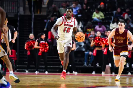 Blake Butler dribbles November 27, 2023 Louisiana vs Loyola New Orleans Men's Basketball in Lafayette, LA at the Cajundome. Final score Louisiana 78 Loyola NO 54. Photo by Benjamin R. Massey/Ragin Cajun Athletics
