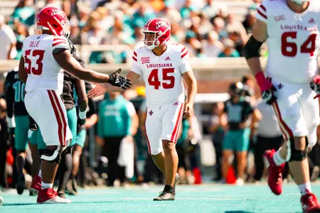 Kenneth Almendares celebrates a field goal with AJ Gillie October 19, 2024 Louisiana @ Coastal Carolina Football in Conway, SC at Brooks Stadium. Final score Louisiana 34 CCU 24. Photo by Benjamin R. Massey/Ragin’ Cajun Athletics