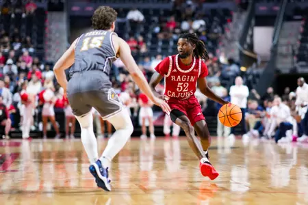 Michael Thomas dribbles November 11, 2024 Louisiana vs Kent State Men's Basketball in Lafayette, LA at the Cajundome. Final score Louisiana 66 Kent State 70. Photo by Benjamin R. Massey/Ragin’ Cajun Athletics