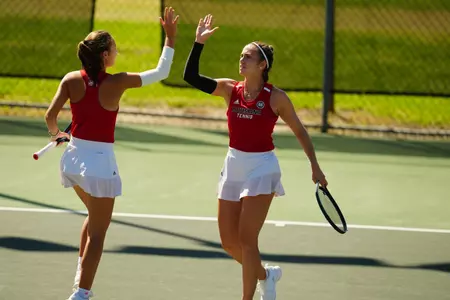 Carla Urchoeguia and Angelique Berrat high five after a point