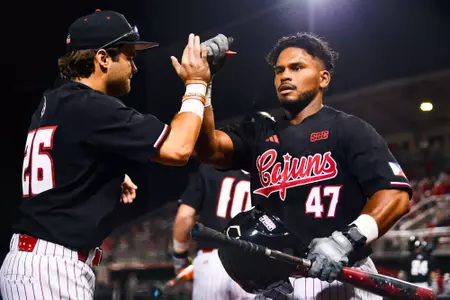 Jose Torres celebrates scoring February 26, 2024 Louisiana vs Rice Game 1 Baseball in Russo Park at M.L. "Tigue" Moore Field. Final Score Louisiana 1 Rice 2. Photo by Benjamin R. Massey/Ragin Cajun Athletics