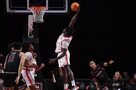 Hosana Kitenge skies for a rebound against Troy