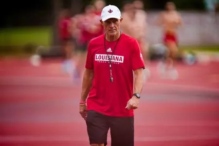 Tommy Badon watches his team practice