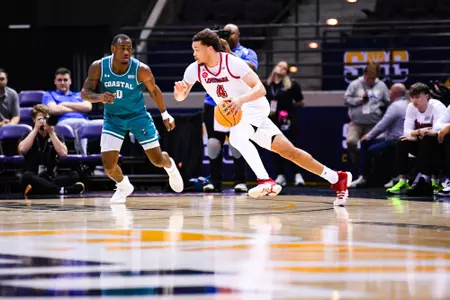 Kobe Julien dribbles March 7, 2024 Louisiana vs Coastal Carolina Men's Basketball in Pensacola, FL at the Pensacola Bay Center. Final score Louisiana 80 Coastal Carolina 66. Photo by Benjamin R. Massey/Ragin Cajun Athletics