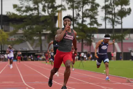 Jamhad Booth celebrates winning the 4x100