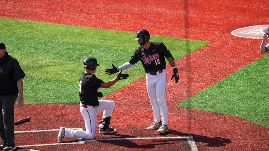 Caleb Stelly congratulates Duncan Pastore after scoring a run in Saturday's 13-1 win over Old Domionion