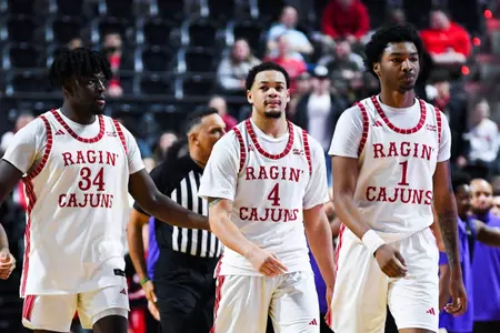 Hosana Kitenge, Kobe Julien, and Joe Charles come off the floor