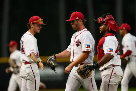 Andrew Herrmann high fives teammates after an inning May 16, 2024 Louisiana vs South Alabama Baseball in Russo Park at M.L. "Tigue" Moore Field. Final Score Louisiana 6 USA 5. Photo by Benjamin R. Masssey/Ragin’ Cajun Athletics