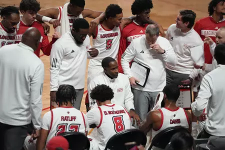 Derrick Zimmerman coaches the team in the huddle