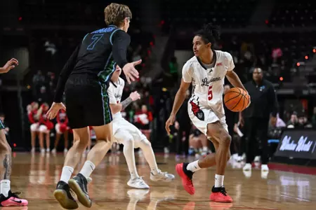 Joshua Lewis looks for an open man and is guarded by Tulane's Rowan Brumbaugh on Tuesday at the Cajundome