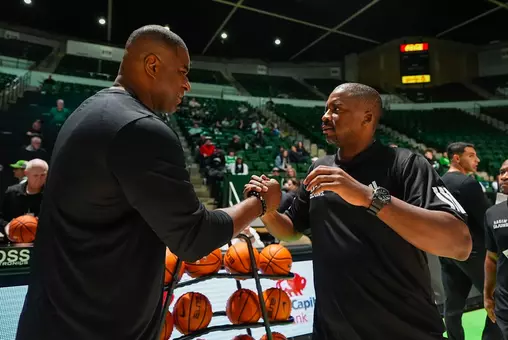Louisiana head coach Quannas White greets North Texas coach Daniyal Robinson prior to an exhibition game in Denton, Texas